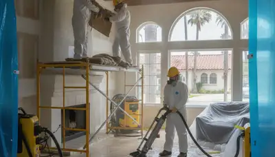 Irvine, CA water damage restoration team inspecting flood damage and cleanup site